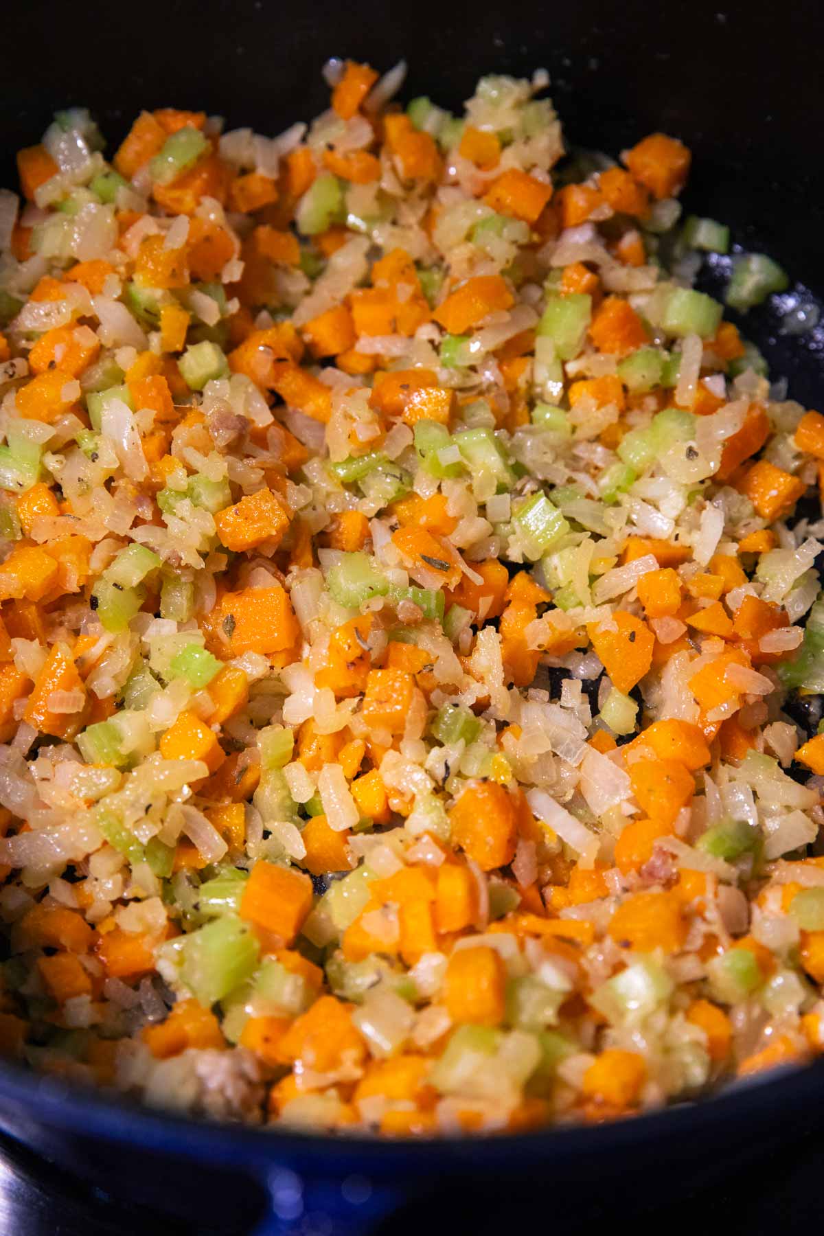 Sautéed vegetables with roux in a cast iron pot.