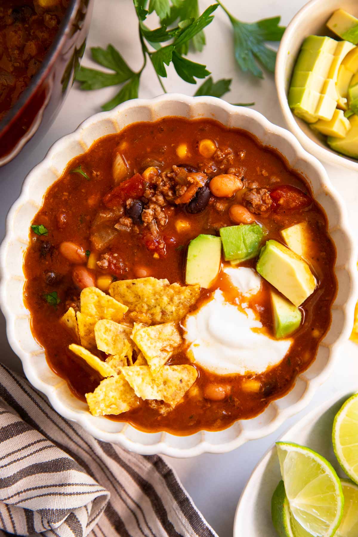 Bowl of taco soup with toppings.