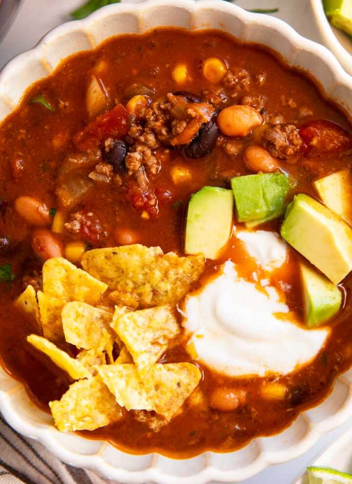 Bowl of taco soup with toppings.
