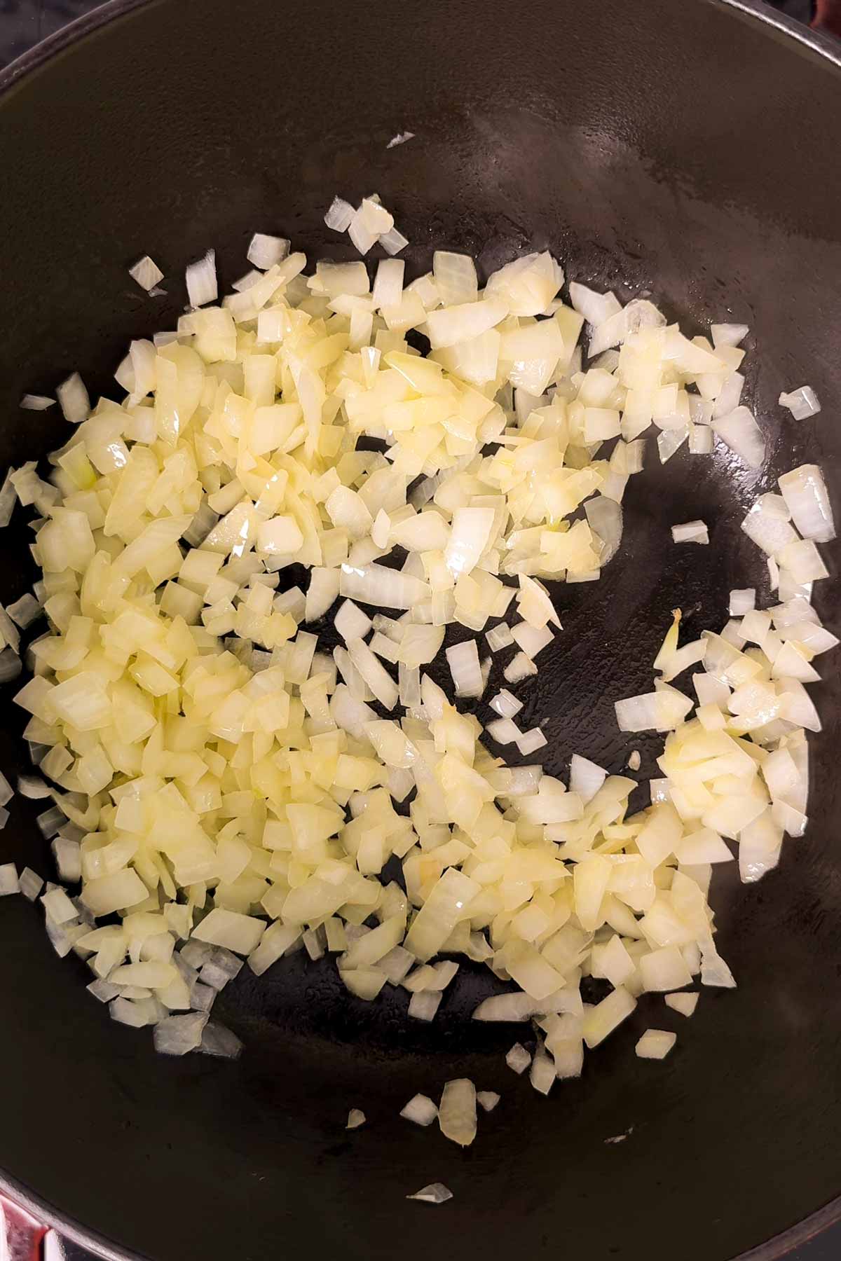 Sautéed onion in a cast iron pot.