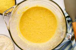 Cornbread batter in glass bowl before adding flour.