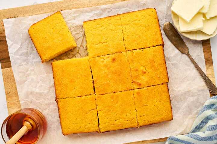Sliced cornbread on a wooden board.