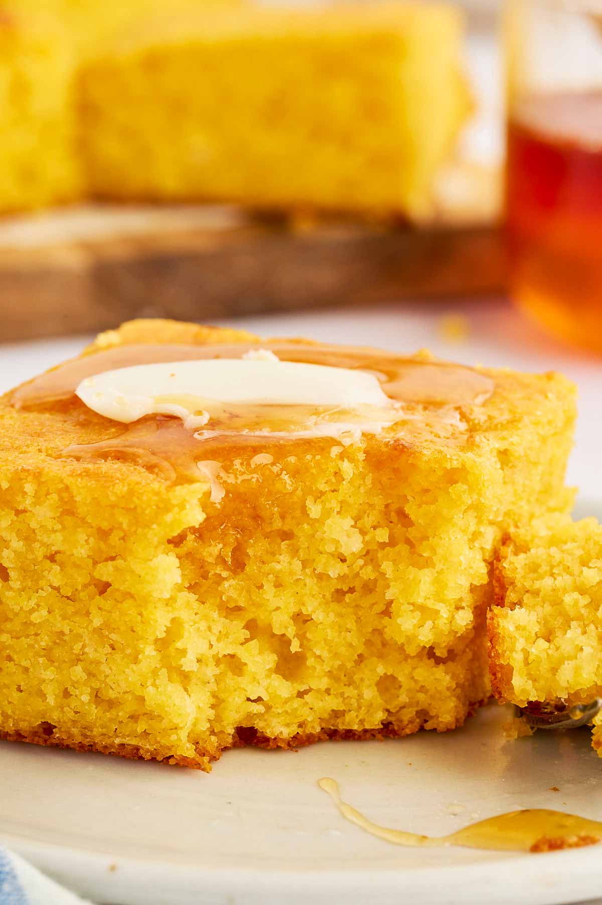 Close up photo of cornbread slice with a bite taken out.